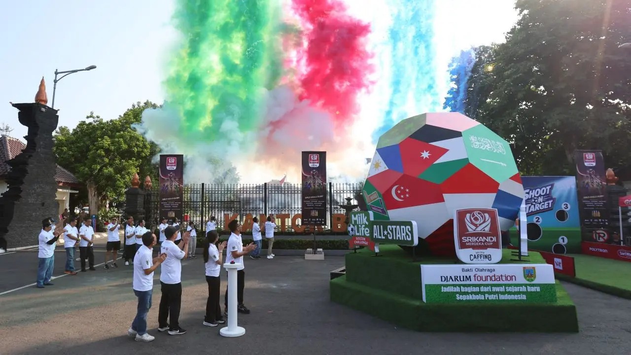 Kick-off of the Women's Soccer Trilogy 2026 at Alun-alun Simpang 7 Kudus, with coloured smoke and a giant football display