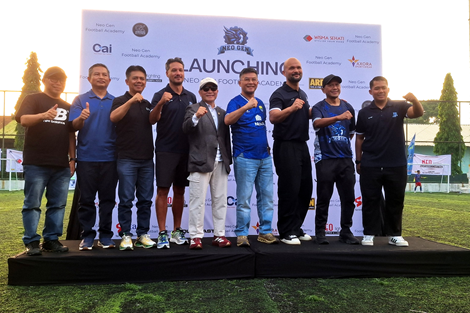 Officials and former Persib players pose on stage in front of the Neo Gen Football Academy launching backdrop in Bandung